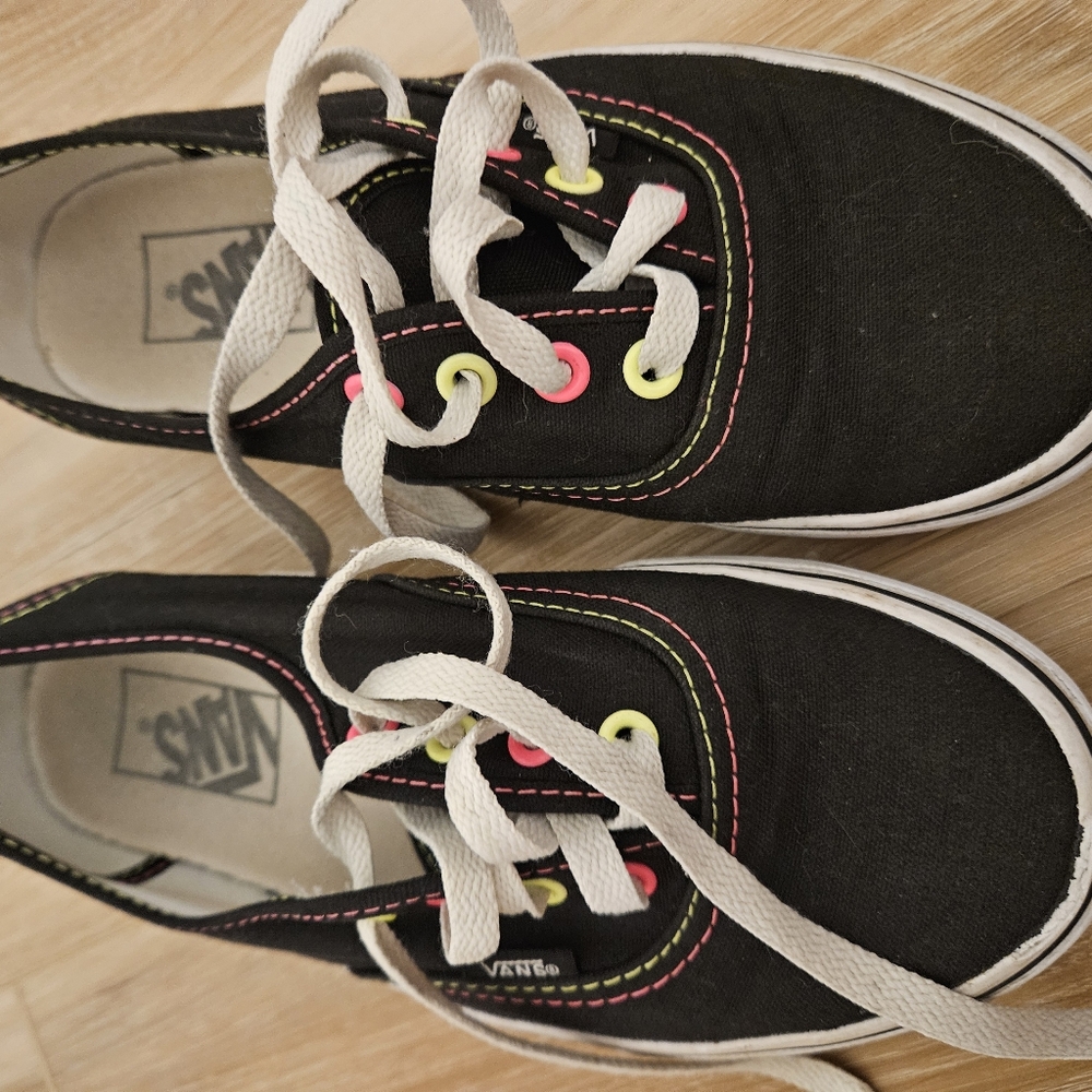 Vans sneakers black with neon and yellow stitching.
